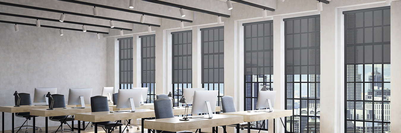 Gray window shades on tall office windows