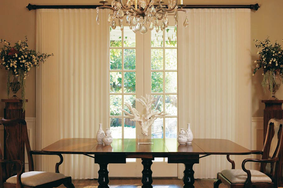 White drapes on French doors in a formal dining room