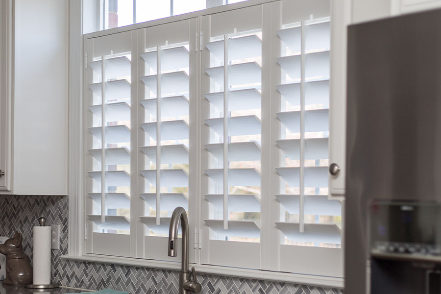 White Polywood shutters on a kitchen window