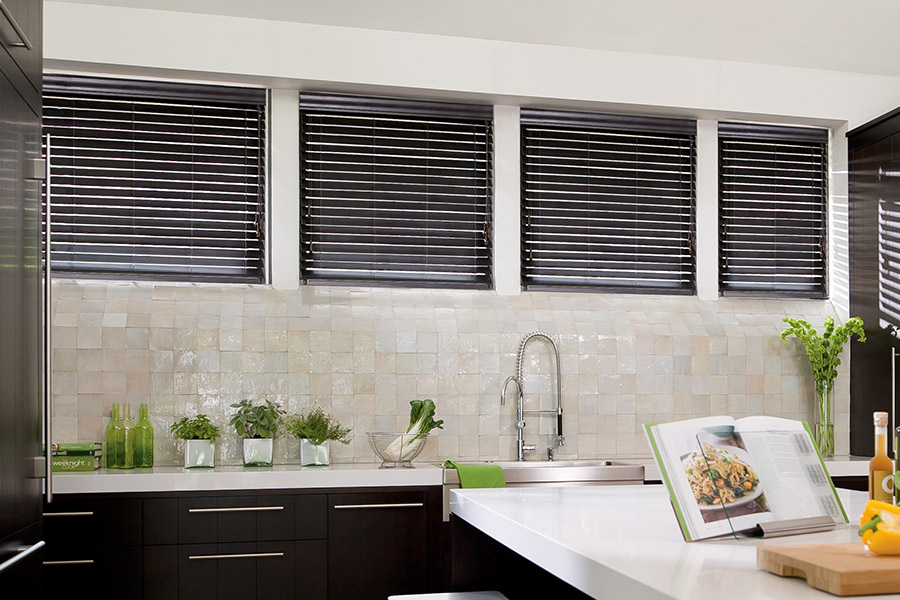 Choose custom Polywood faux wood blinds for your kitchen in Cincinnati. Special shaped faux wood blinds in several windows above a sink.